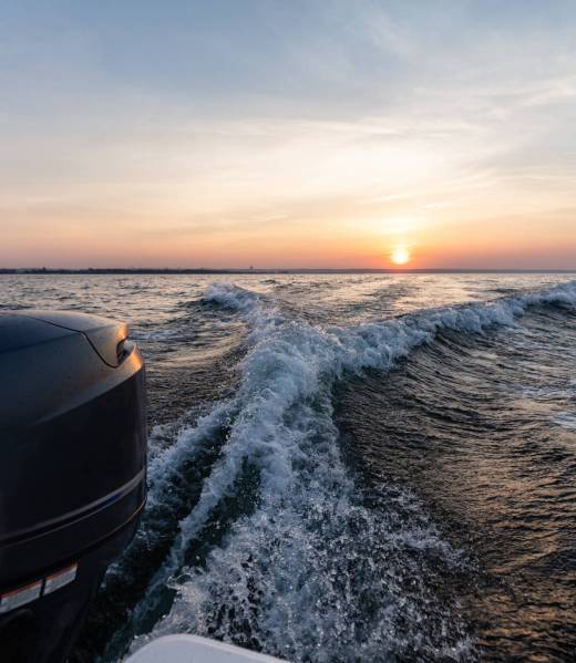 Fast motorboat ride on sea at sunset. Wake pattern behind